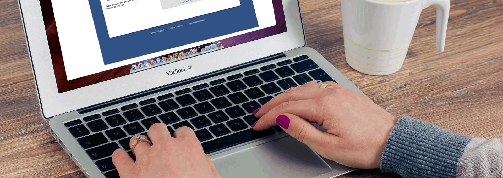 Person completing application on laptop