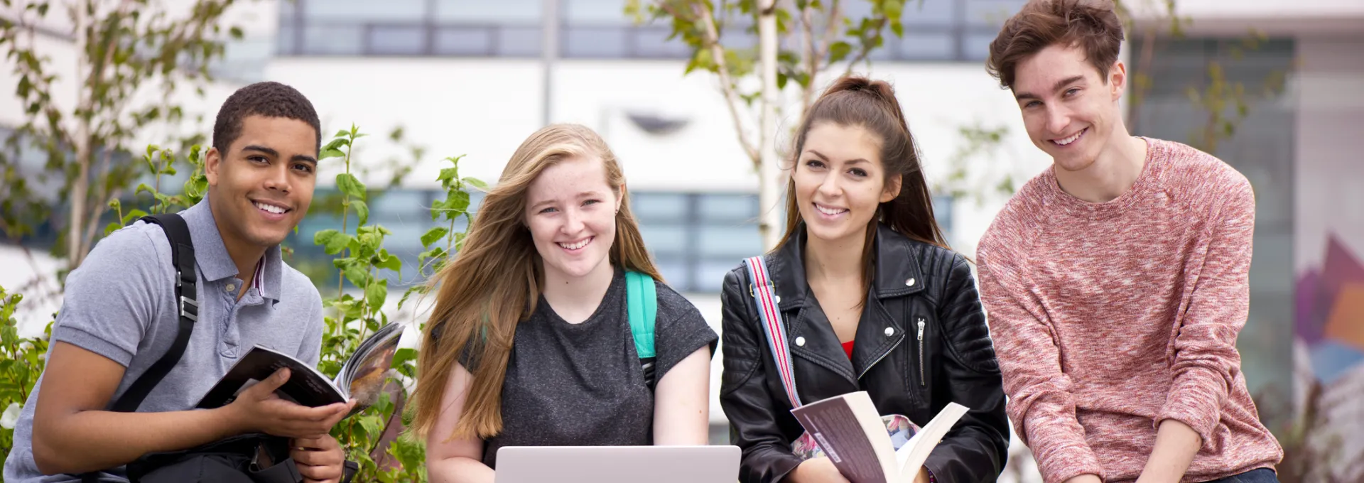 college students sitting on a bench