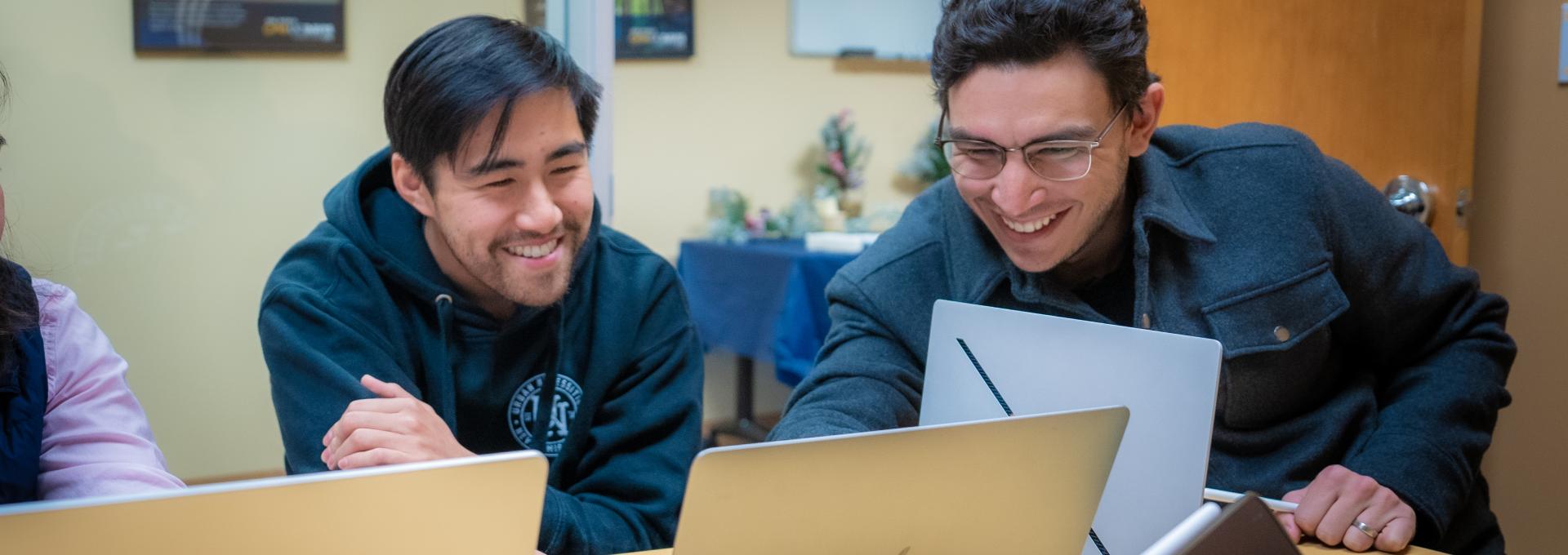 students looking at laptop
