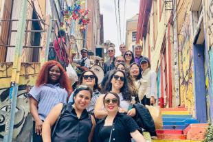 MBA students in Chile, standing on a colorful outdoor staircase