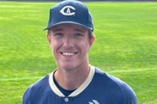 Carter Delaney wearing a baseball uniform and standing on the baseball field