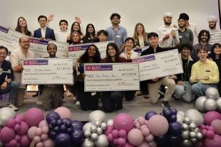 winners on stage with checks