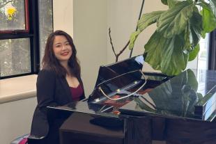 Via Lin sitting at a piano