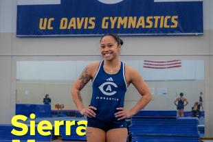 Sierra Muns standing on gymnastics mat