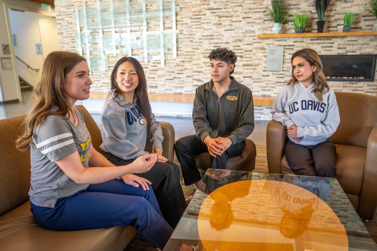 Four MPAc students sitting in Gallagher Hall lobby