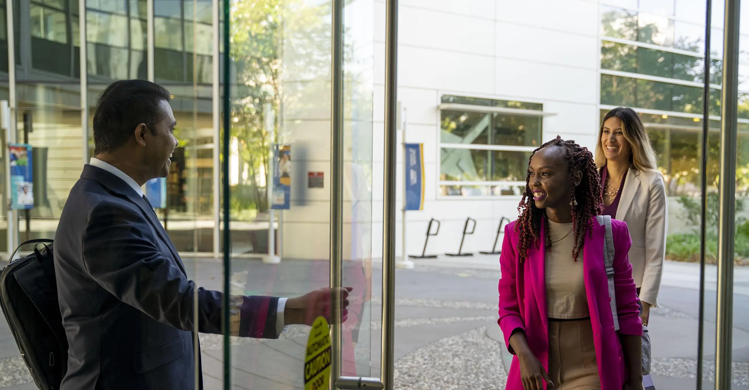 Three Sacramento Part-Time MBA students entering the Education Building