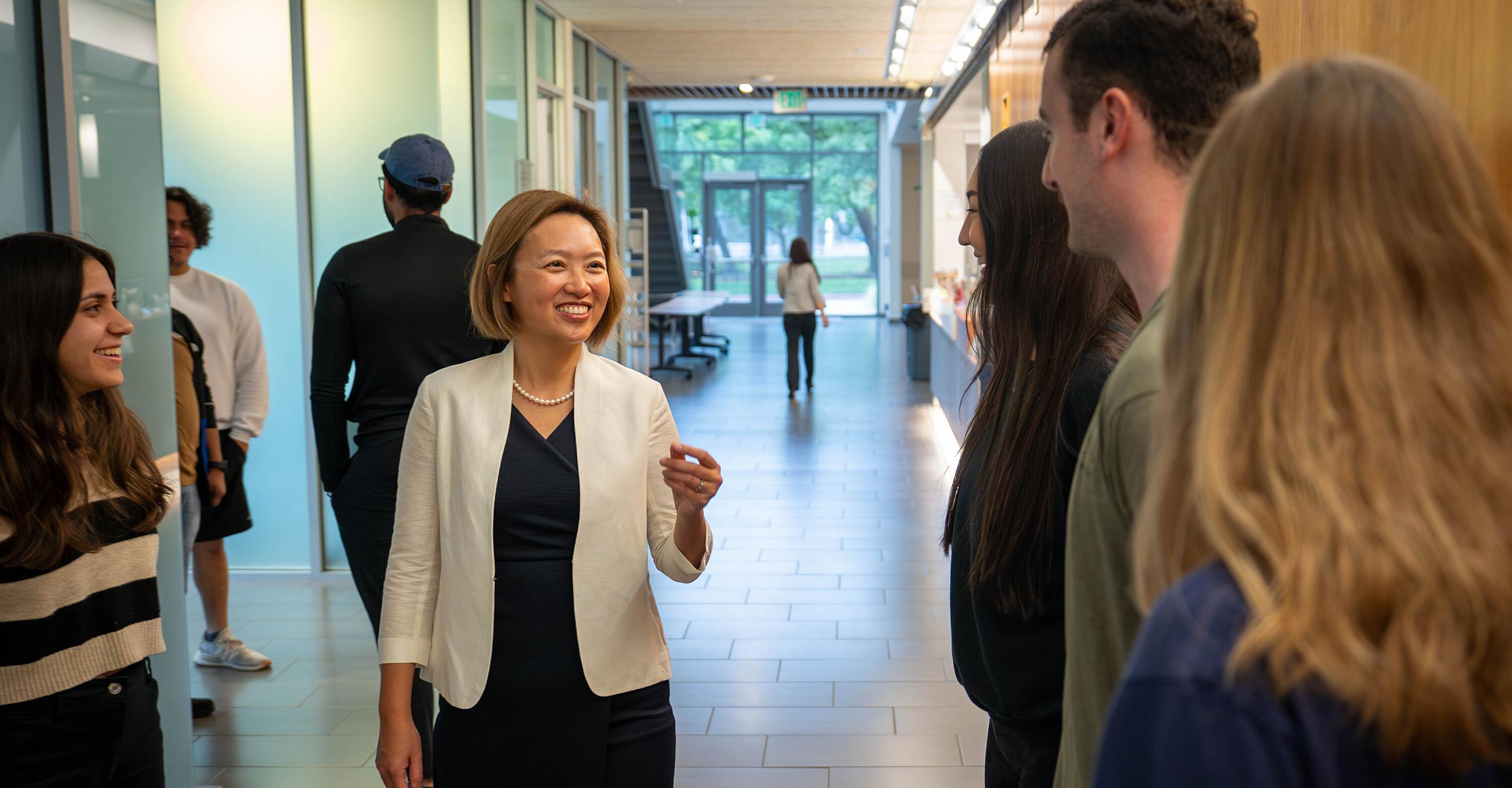 Students talking to a faculty member in Gallagher Hall