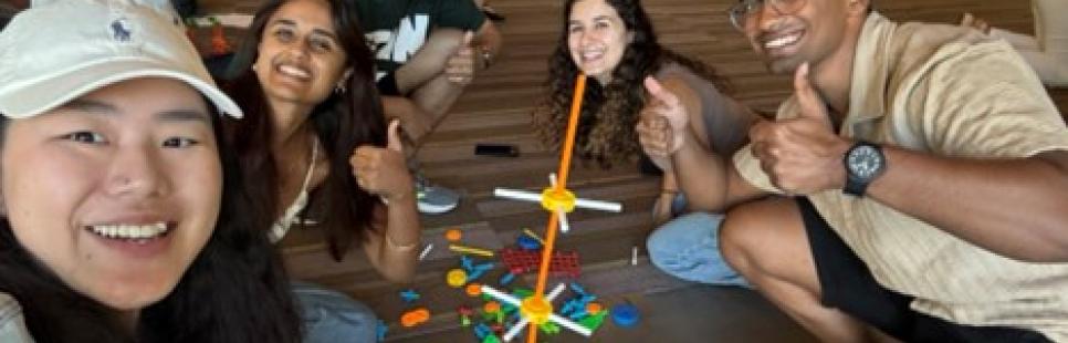 Sarah Deng with MBA students building toy structures