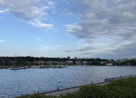 Lake Saimaa in Lappeenranta, Finland, with sailboats docked at the marina and a bright blue sky with scattered clouds overhead