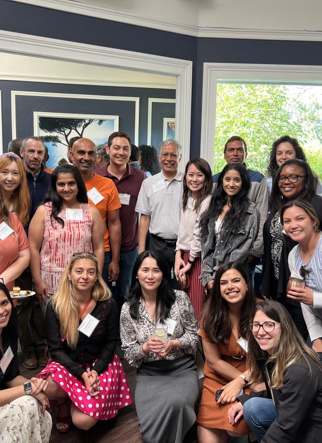 Group of individuals posing in front of camer