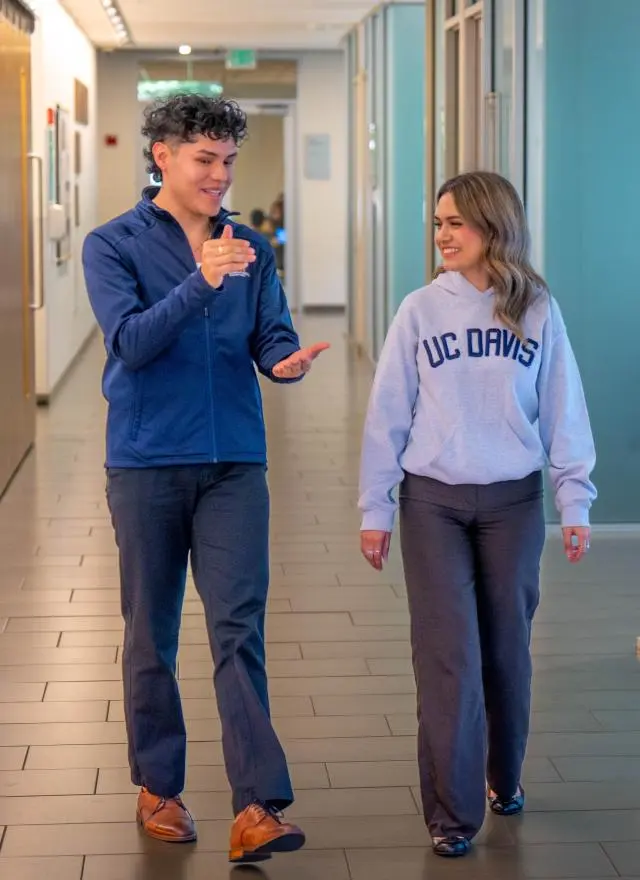 Two MPAc students walking in Gallagher Hall lobby