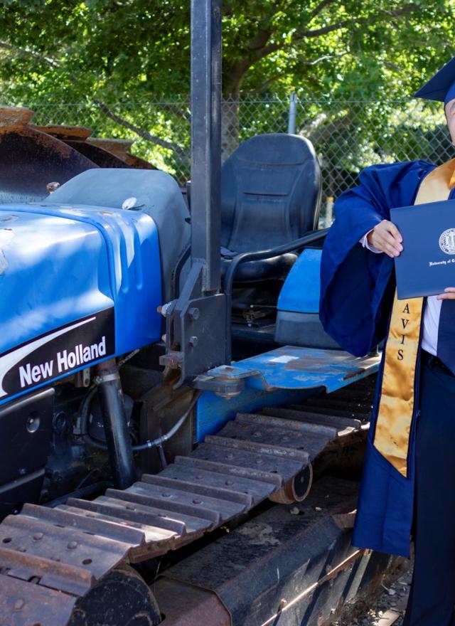 Michael Hui holding his diploma