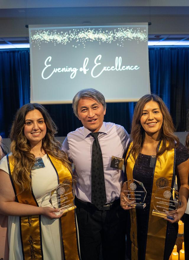 winners holding trophies and certificates