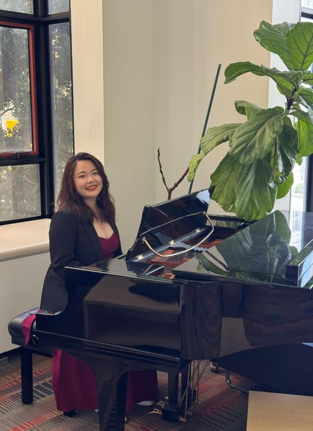Via Lin sitting at a piano
