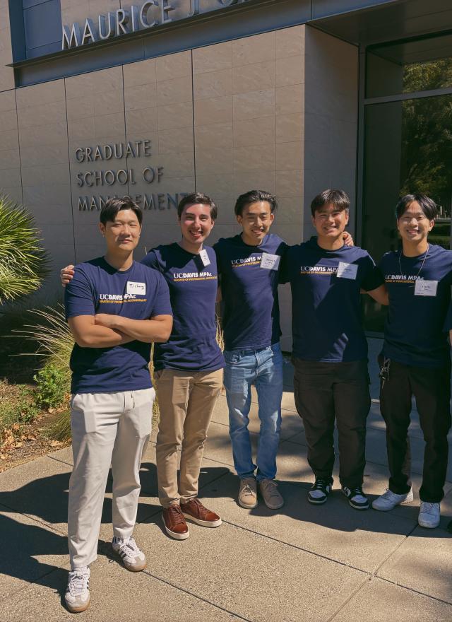 Chris Ngan and other MPAc students stand in front of Gallagher Hall