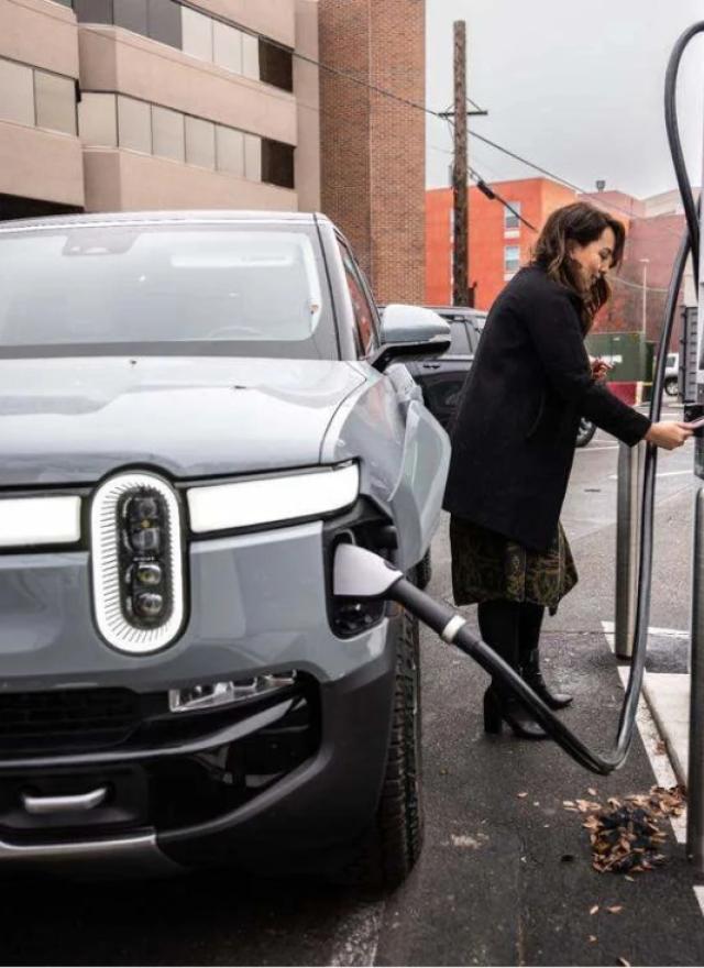 Woman charging EV at charger