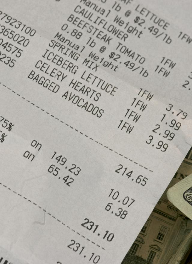 grocery receipt alongside $20 bills 