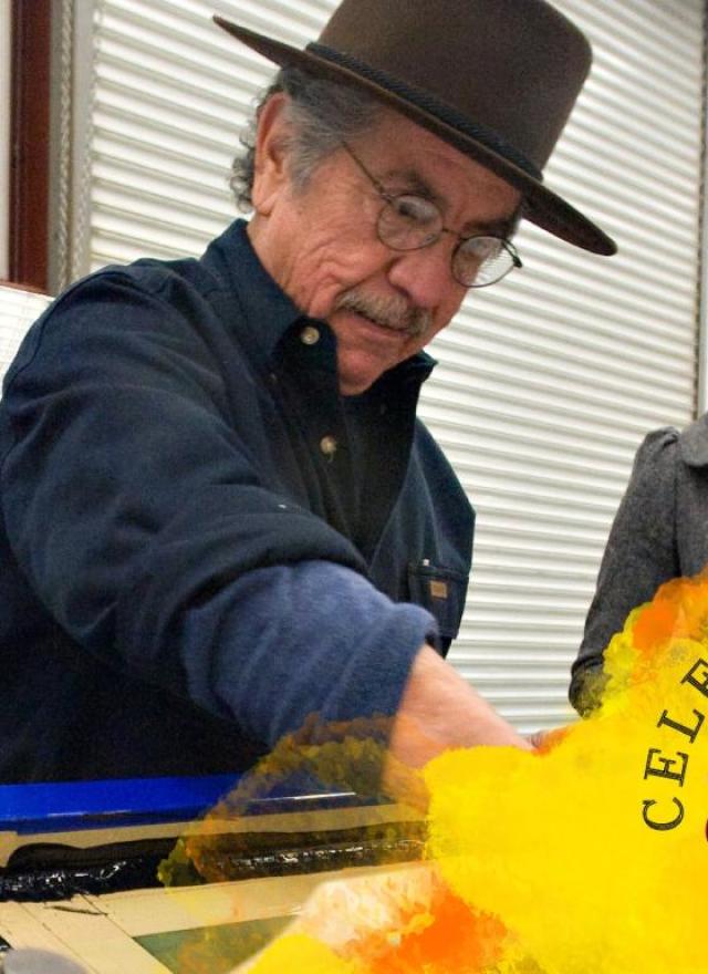 A group of people participate in a hands-on screen-printing activity in a workshop space. An older man wearing a hat demonstrates the process while others look on and smile. A colorful graphic overlay reads “Celebrating 35 Years of Community.”