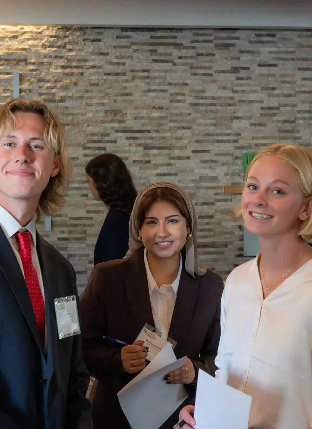 Three Master of Management students dressed in professional attire