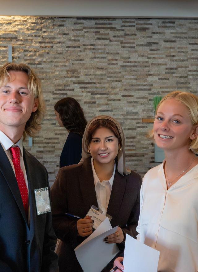 Three Master of Management students dressed in professional attire