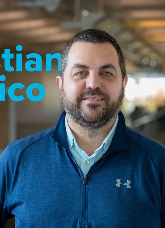 A man in a blue jacket stands indoors; text next to him reads "Sebastian Calonico We Are GSM.