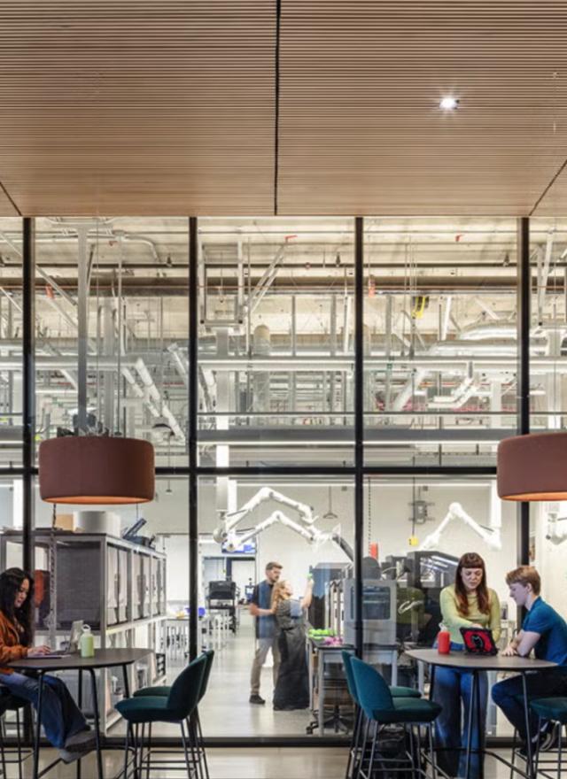People sit outside of the Tech Foundry, a makerspace at Aggie Square that designs and manufactures devices to support research and solve problems.