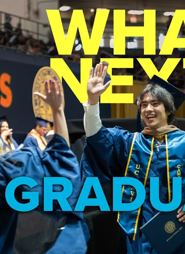 Two UC Davis graduates in caps and gowns high-five at a commencement ceremony. Large text reads "WHAT'S NEXT? GSM GRADUATES.
