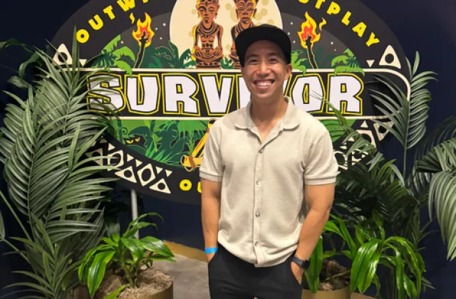 Kevin Leung in front of a banner that reads Survivor