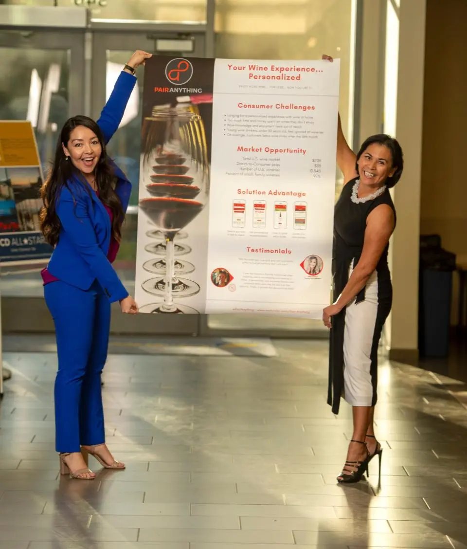 Christy Serrato and Samantha Contreras holding up their poster at the Big Bang! competition