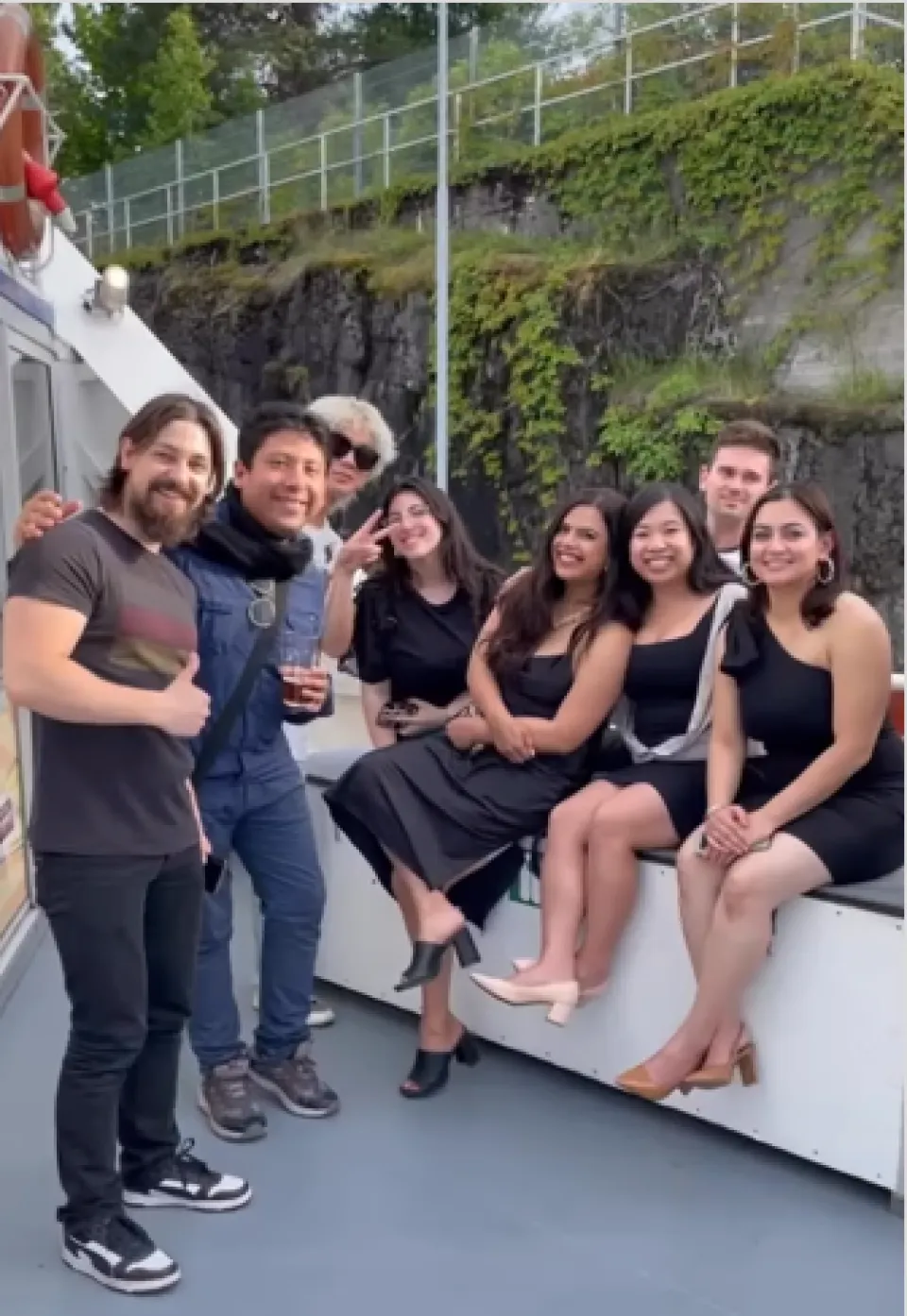 Prachi Mishra sitting on a boat deck with MBA students