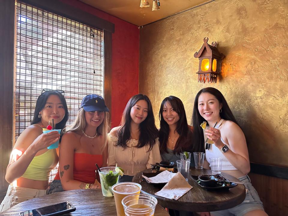 group of students sitting at a restaurant table