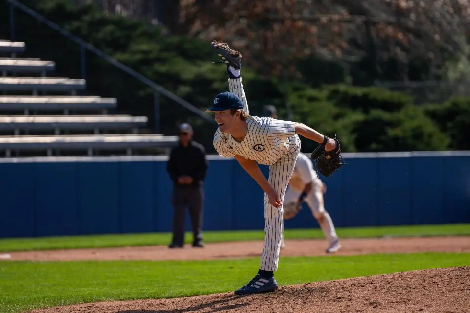 Carter Delaney, in a baseball uniform, pitching a ball from the mound.