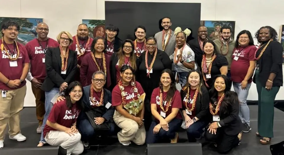 Maikhou Thao and her EIC team members wearing medals