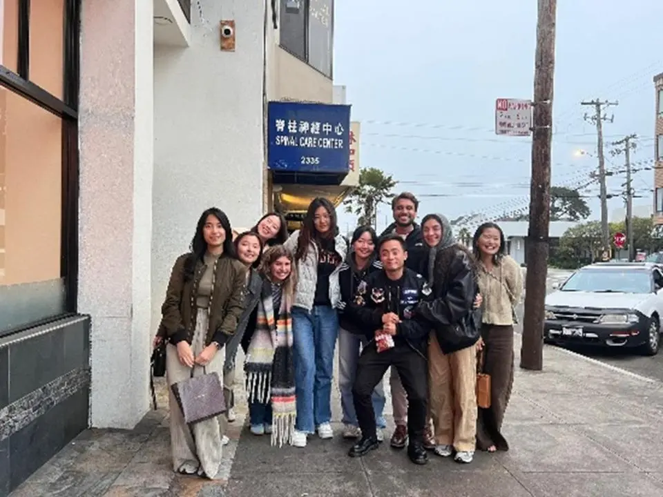 Ji Hyun Kim with group of friends. standing on sidewalk in San Francisco