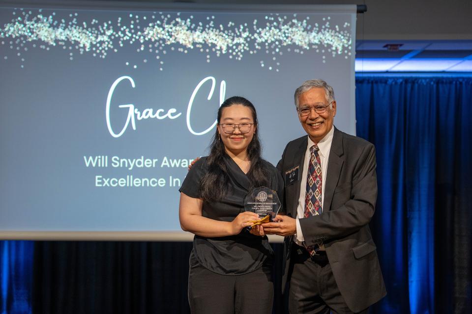 Grace Cha on-stage receiving award from Dean Rao Unnava