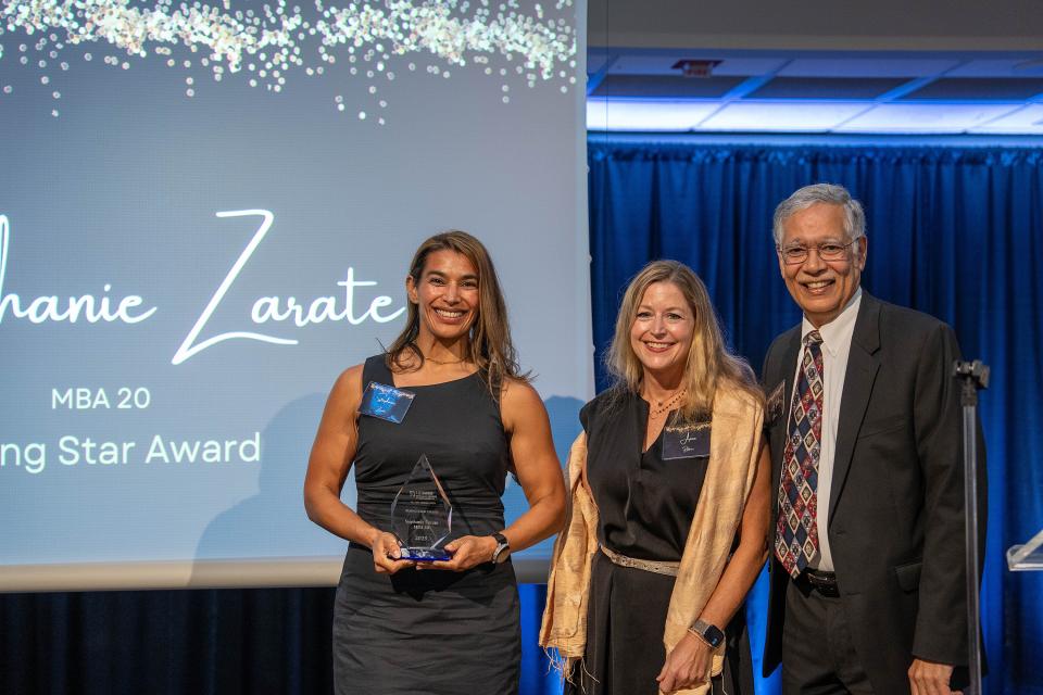 Stephanie Zarate on-stage receiving award from Dean Rao Unnava