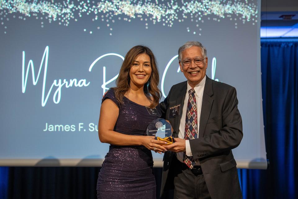 Myrna Robles Couch on-stage receiving award from Dean Rao Unnava