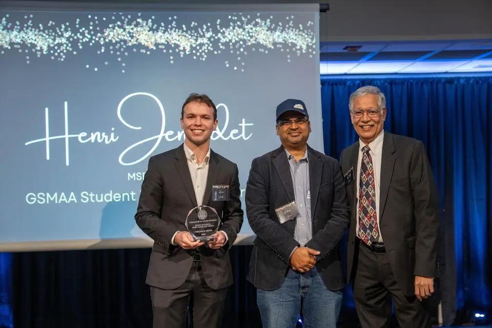 Henri Jenoudet on-stage receiving award from Dean Rao Unnava