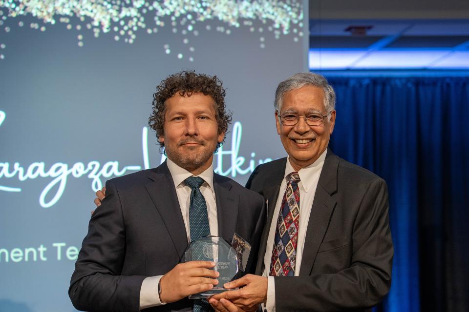 Matthew Zaragoza-Watkins on-stage receiving award from Dean Rao Unnava