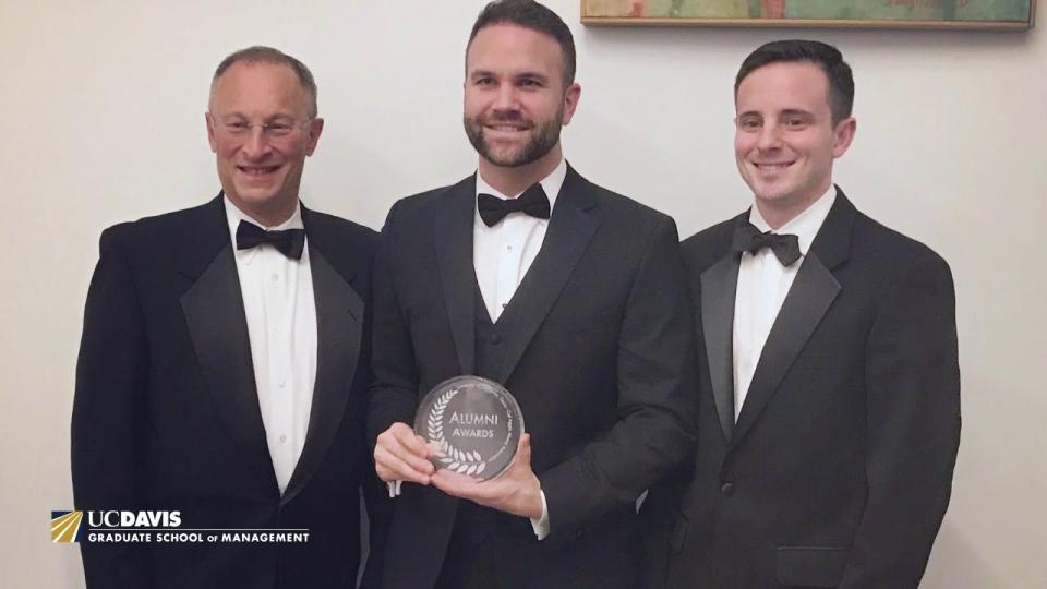 Mac Clemmens holding an award