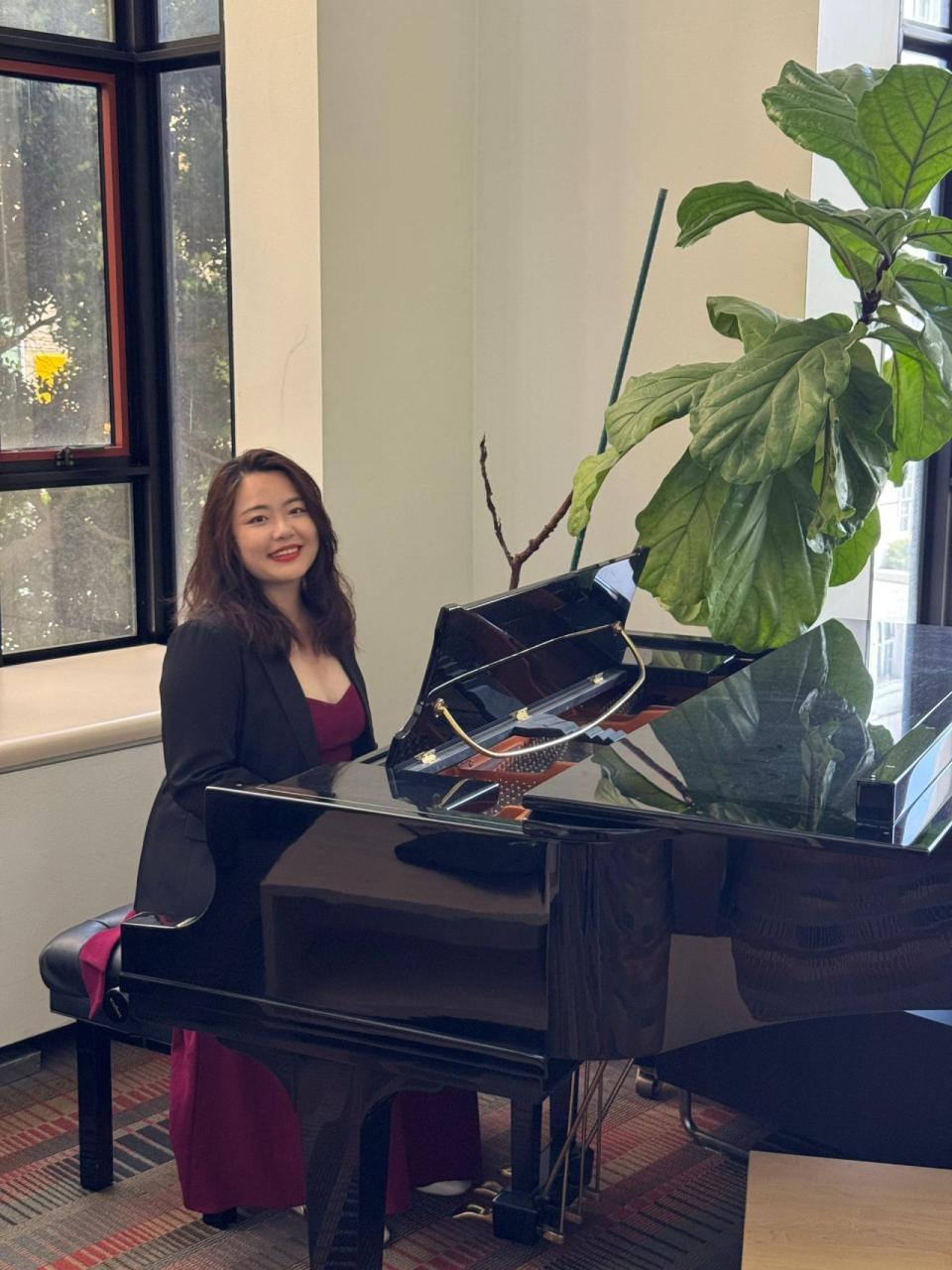 Via Lin sitting at a piano