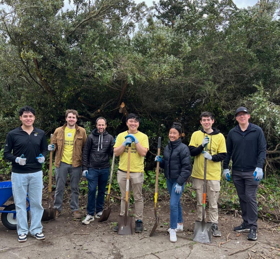 Eduardo Casarubias outside with EY employees