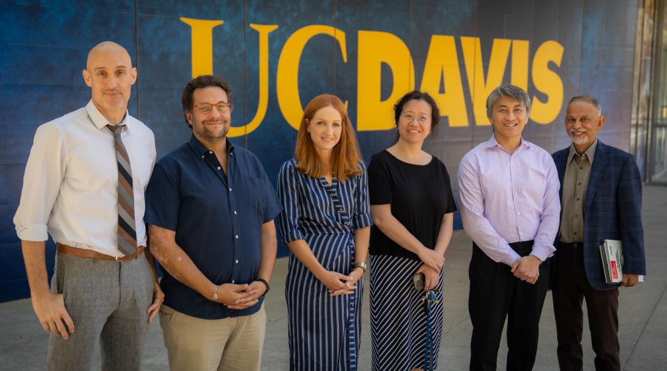 Faculty in front of UC Davis sign