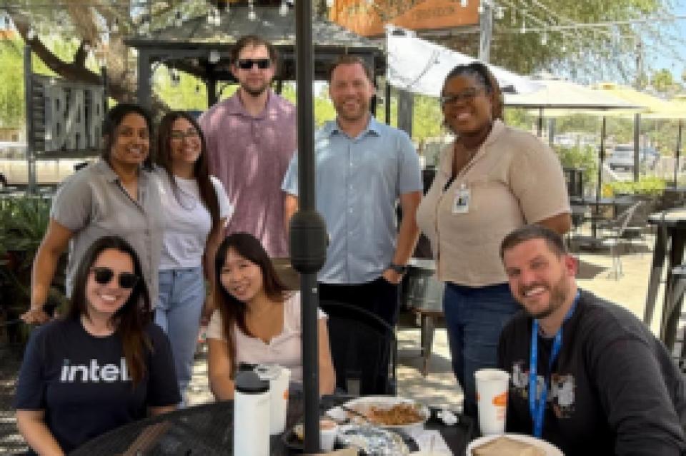 Nathaniel Wentland sitting on a patio with other Intel interns
