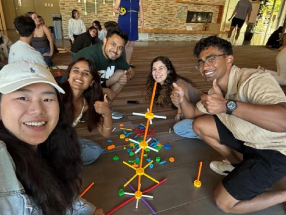 Sarah Deng with MBA students building toy structures