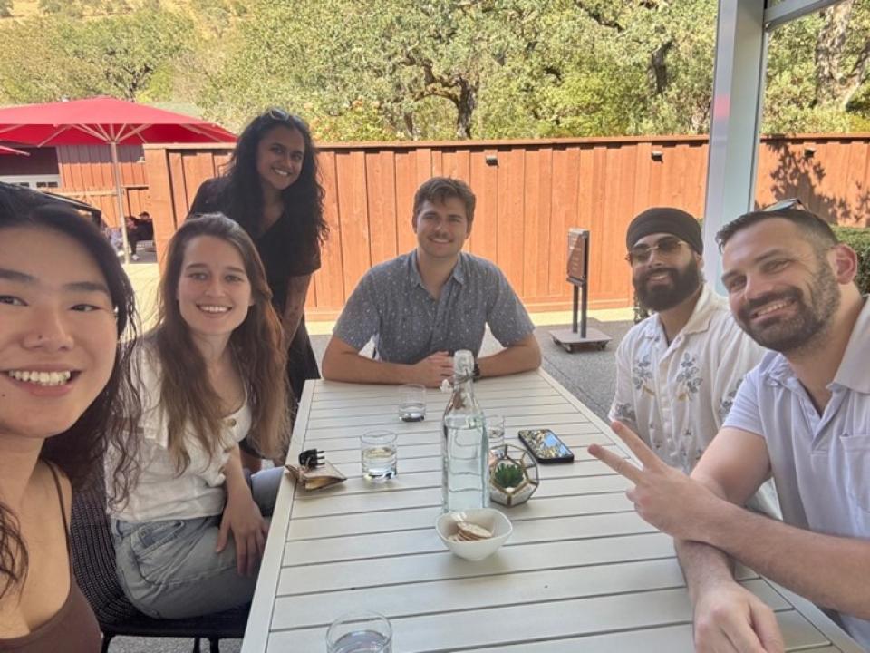MBA students sit on an outside patio at a winery