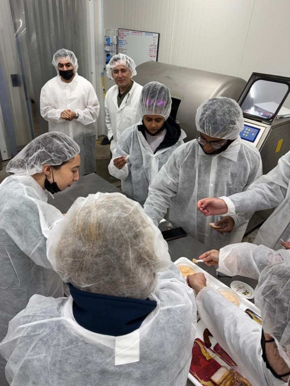 Students wearing protective wear in a sterile lab