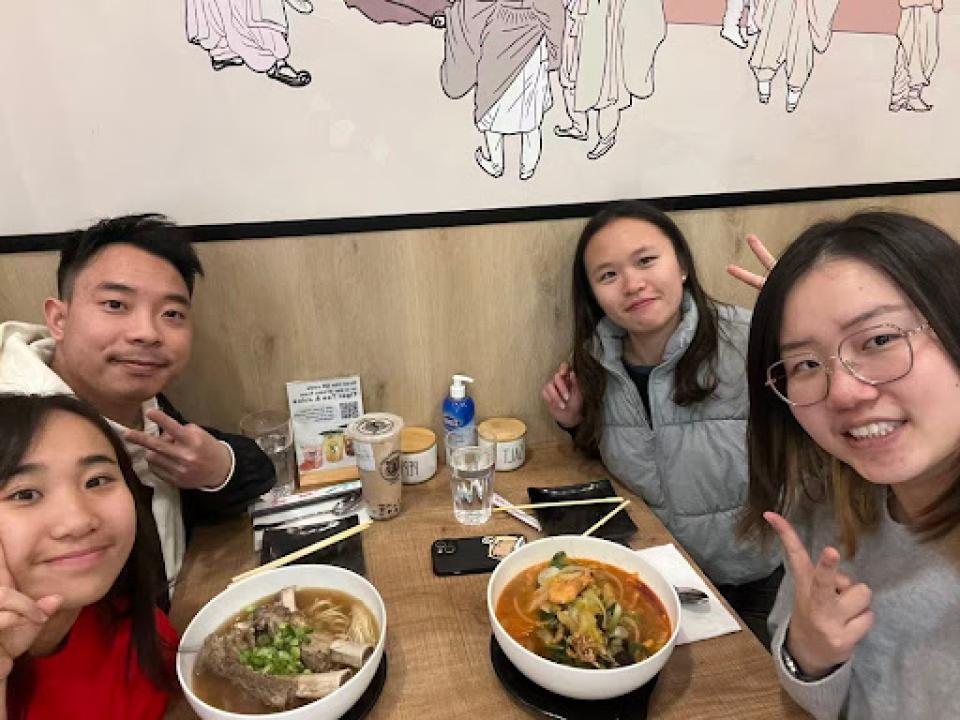 Selina Bina eating lunch in a restaurant with other MSBA students