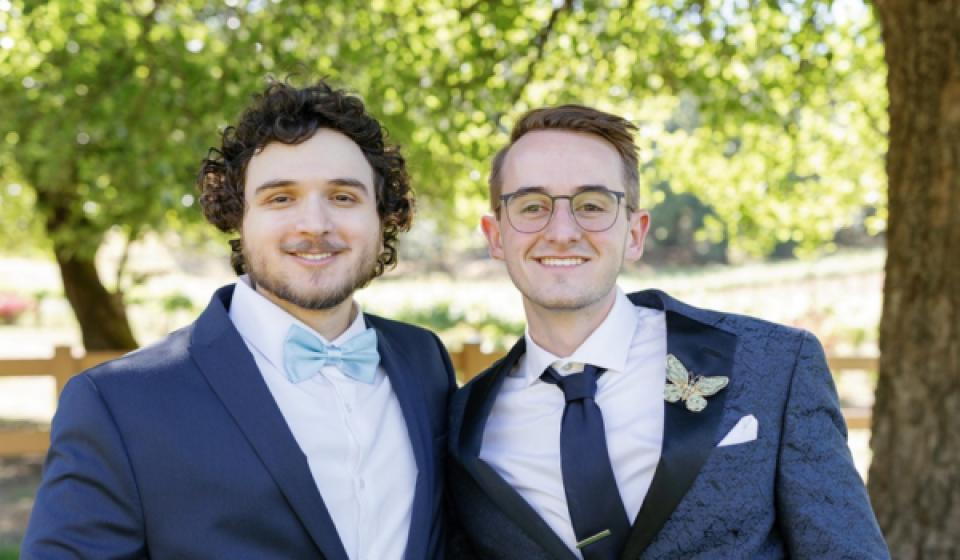 Dillon Hill and Yamin Elshaer standing side-by-side in wedding attire
