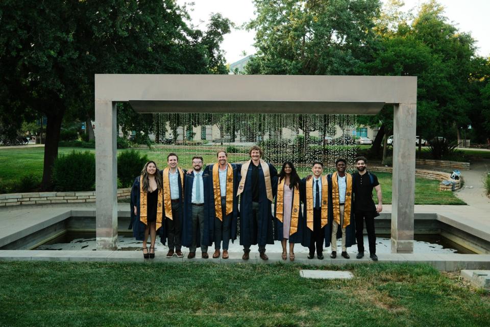 Roshan Paul and Class of 2025 in front of a fountain on UC Davis campus